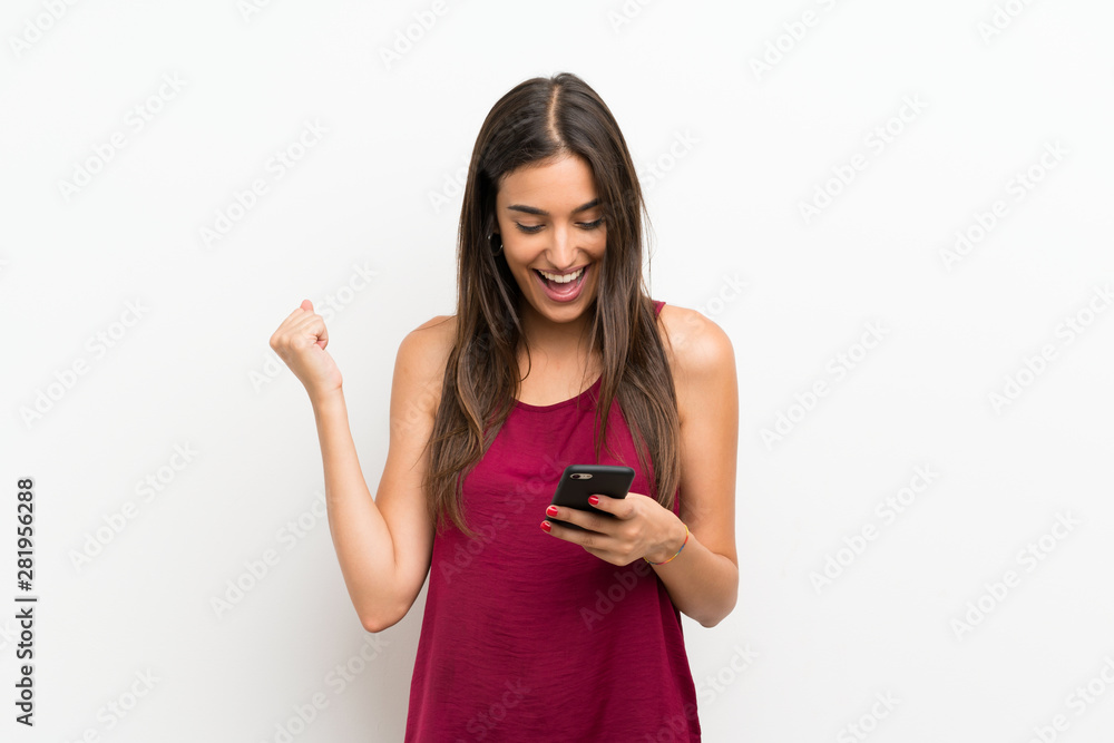 Young woman over isolated white background using mobile phone Young woman over isolated white background using mobile phone