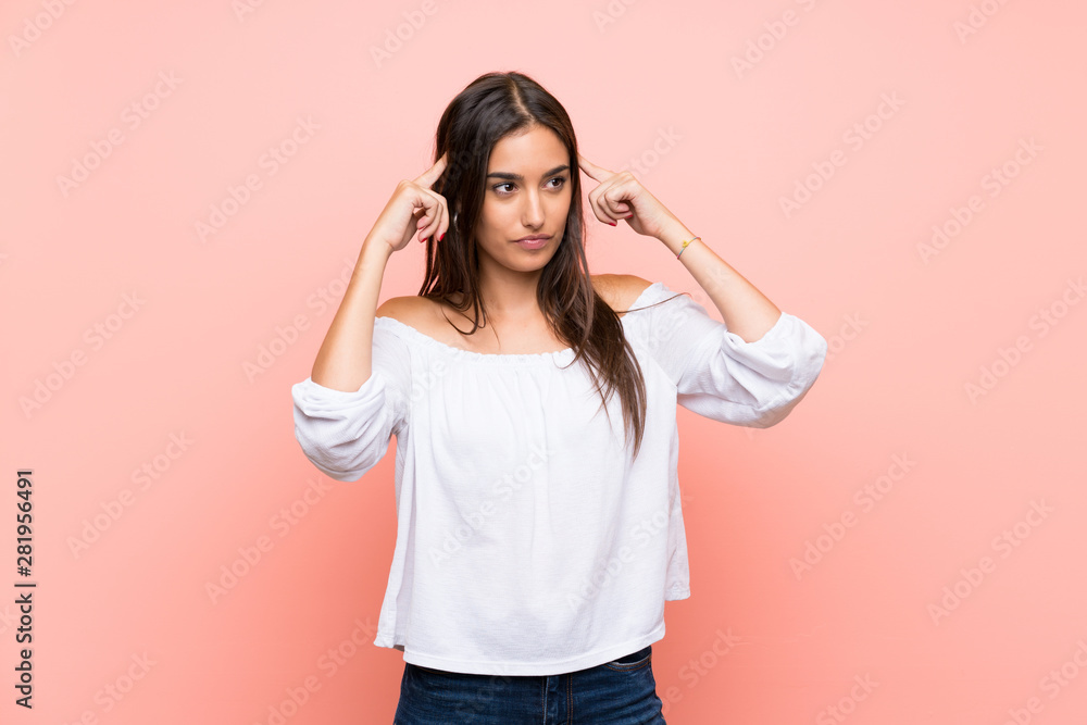 Young woman over isolated pink background having doubts and thinking Young woman over isolated pink background having doubts and thinking