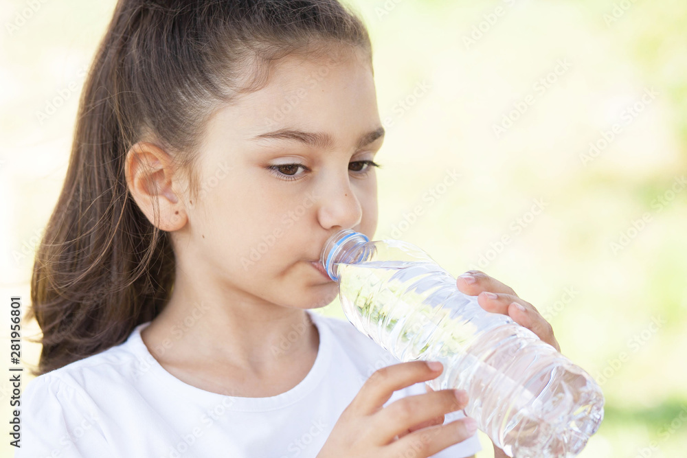 Cute adorable child girl drinking clear water outdoors. Cute adorable child girl drinking clear water outdoors.