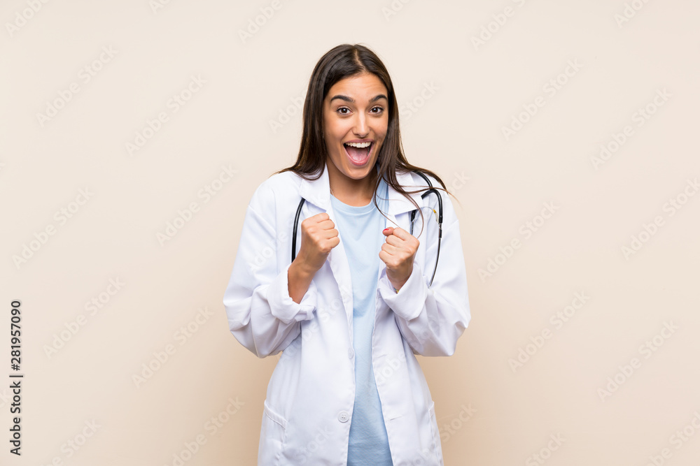 Young doctor woman over isolated background celebrating a victory Young doctor woman over isolated background celebrating a victory