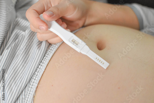 The stomach of a woman with a pregnancy check