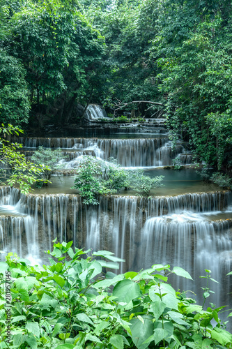 A beautiful waterfall among the forest in Thailand. It is the best place for camping to feel fresh air, green leaves and peaceful nature during holiday. © Teerachai