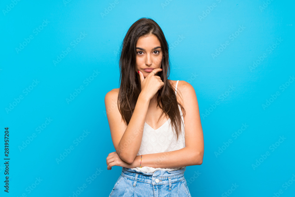 Young woman over isolated blue background thinking Young woman over isolated blue background thinking