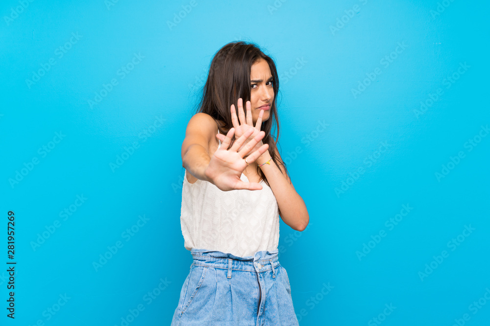 Young woman over isolated blue background nervous stretching hands to the front Young woman over isolated blue background nervous stretching hands to the front