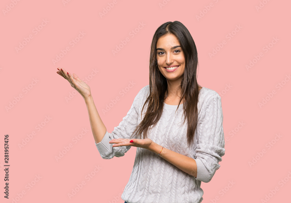 Young hispanic brunette woman extending hands to the side for inviting to come over isolated background Young hispanic brunette woman extending hands to the side for inviting to come over isolated background