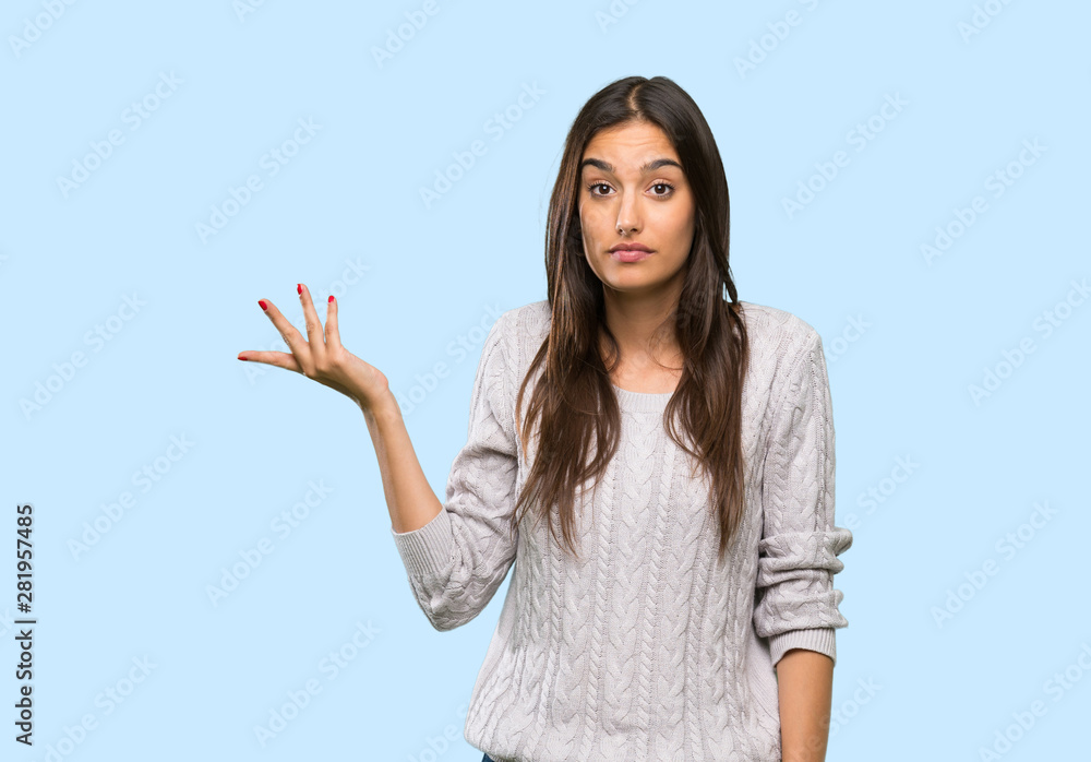 Young hispanic brunette woman making doubts gesture over isolated background Young hispanic brunette woman making doubts gesture over isolated background