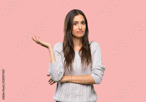 Young hispanic brunette woman unhappy for not understand something over isolated background