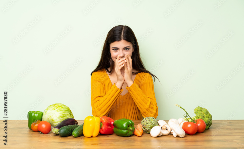 Teenager girl with many vegetables scheming something Teenager girl with many vegetables scheming something