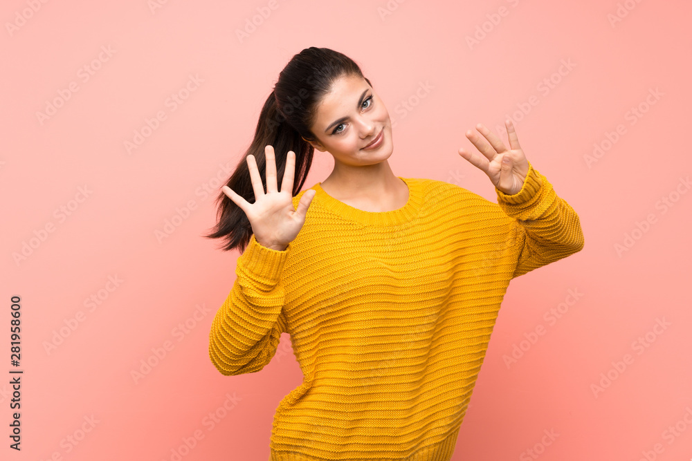 Teenager girl over isolated pink wall counting nine with fingers Teenager girl over isolated pink wall counting nine with fingers