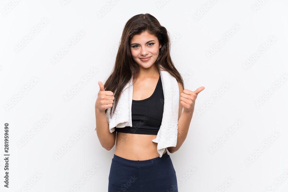 Teenager sport girl over isolated white background giving a thumbs up gesture Teenager sport girl over isolated white background giving a thumbs up gesture