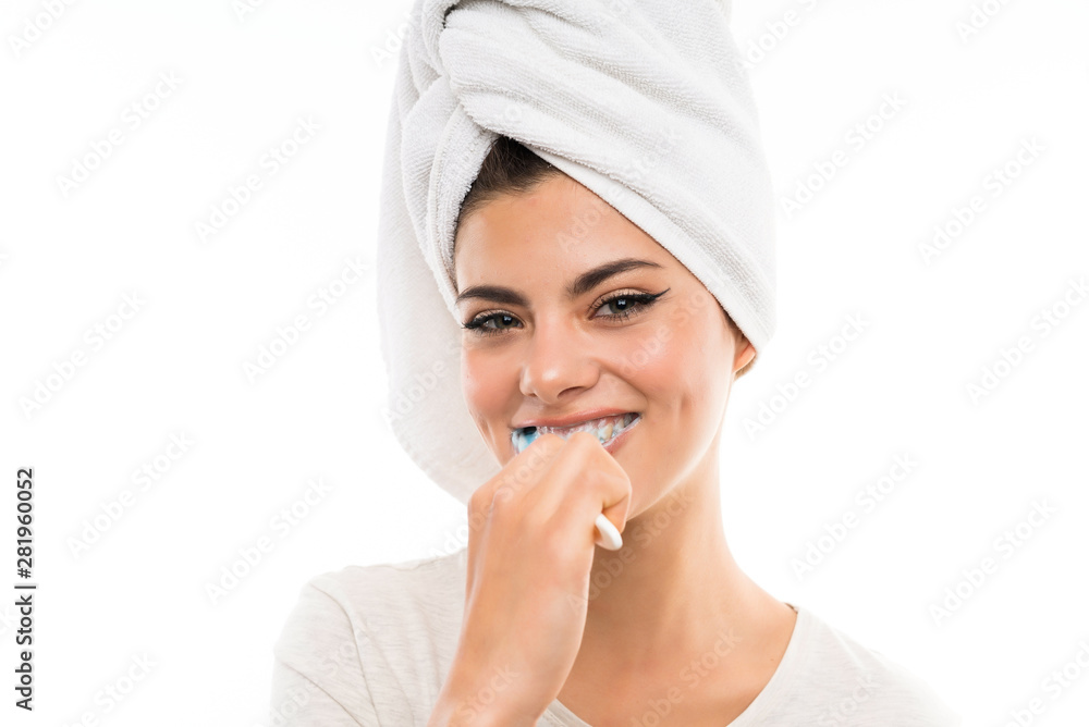 Teenager girl over isolated white background brushing her teeths Teenager girl over isolated white background brushing her teeths