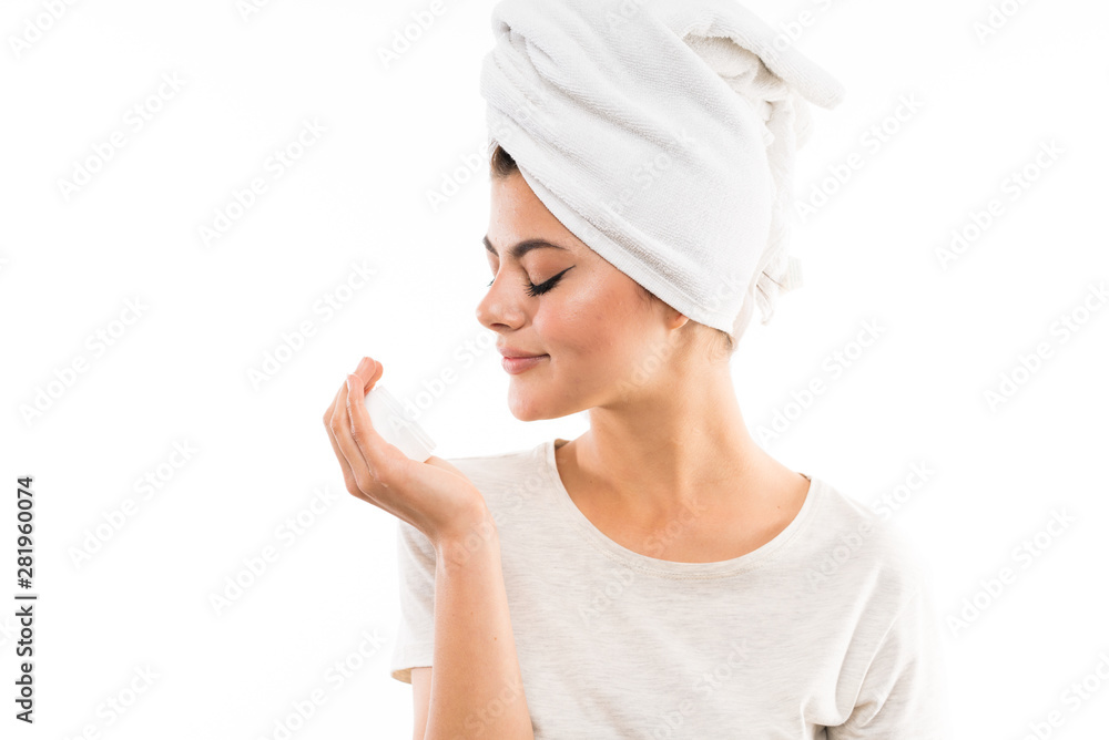 Teenager girl over isolated white background with moisturizer Teenager girl over isolated white background with moisturizer