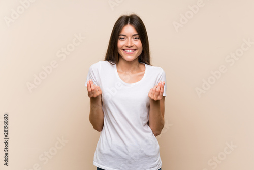 Wallpaper Mural Pretty young girl over isolated background making money gesture Torontodigital.ca