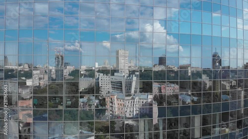 City and blue sky reflection in skyscraper facade windows aerial ascending