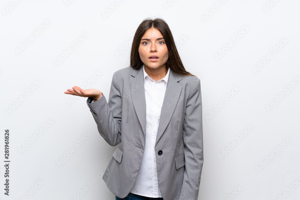 Young business woman over isolated white background making doubts gesture Young business woman over isolated white background making doubts gesture