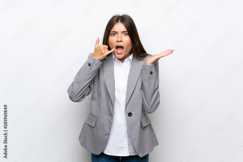 Young business woman over isolated white background making phone gesture and doubting Young business woman over isolated white background making phone gesture and doubting