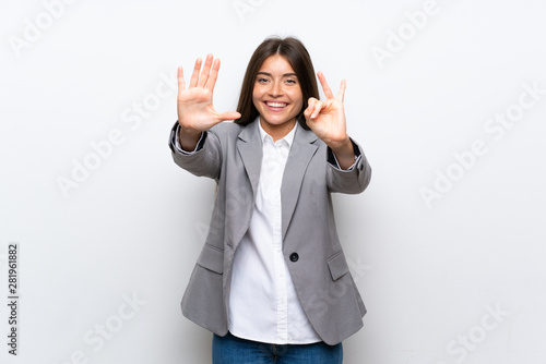 Young business woman over isolated white background counting seven with fingers