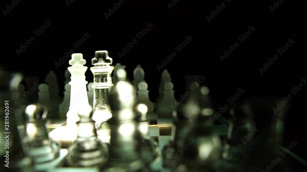 The concept of business competition: Close-up of a businessman holding a glass chess footage slow motion The concept of business competition: Close-up of a businessman holding a glass chess footage slow motion