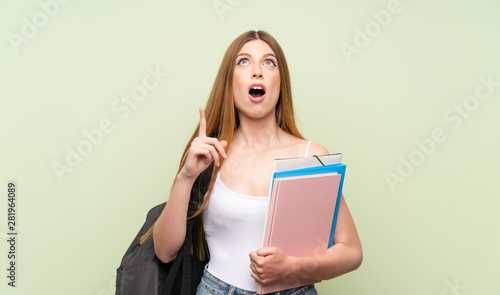 Young student woman over isolated green background pointing with the index finger a great idea