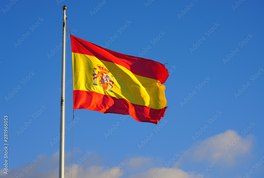 View of the yellow and red Flag of Spain (Bandera de España) floating in the wind View of the yellow and red Flag of Spain (Bandera de España) floating in the wind