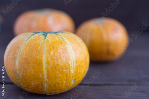 ripe fresh pumpkins on a wooden background,close-up