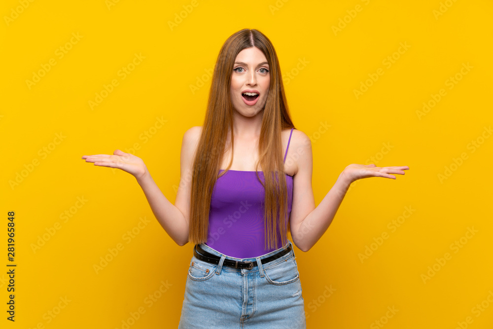 Young woman over isolated yellow background with shocked facial expression Young woman over isolated yellow background with shocked facial expression