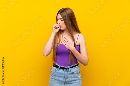 Young woman over isolated yellow background is suffering with cough and feeling bad