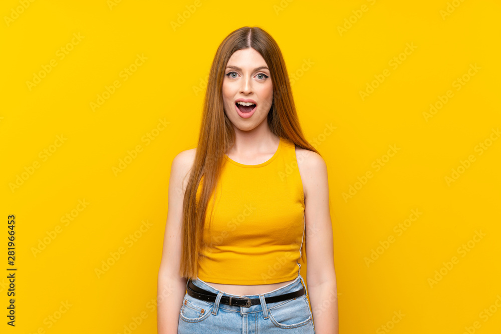 Young woman over isolated yellow background with surprise facial expression Young woman over isolated yellow background with surprise facial expression