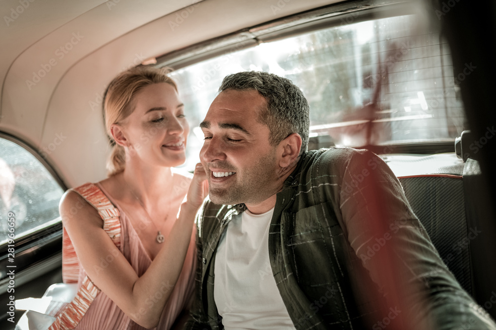 Smiling woman tickling neck of her husband. Smiling woman tickling neck of her husband.