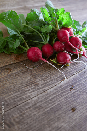 view of nice fresh radish with leafs on wooden background