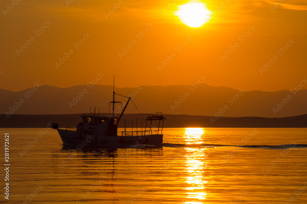 Trawler in the glow of the setting sun.