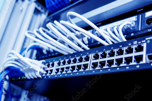 Network switch and ethernet cables in red and white colors. Data Center
