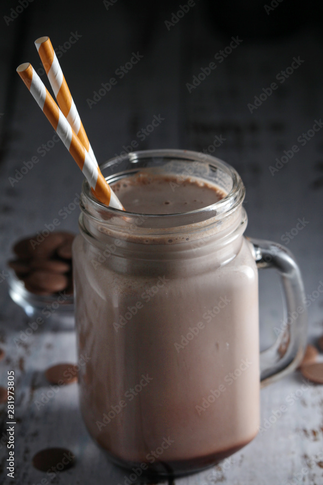 A glass jar with chocolate milk drink A glass jar with chocolate milk drink