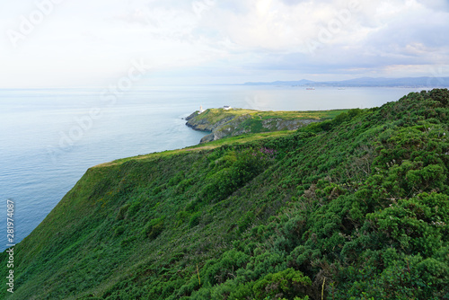 View of green heather fields, the Baily Lighthouse and the Irish Sea seen from the Howth Summit in Howth, near Dublin, Ireland