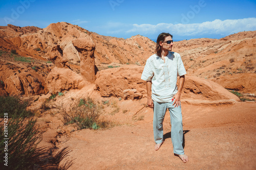 the guy stands on top of a mountain