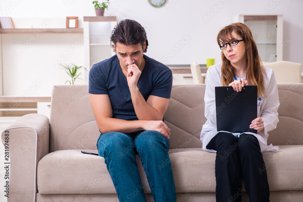 Young male patient discussing with female psychologist personal