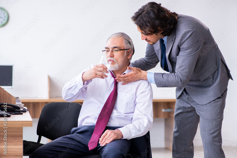 Male employee suffering from heart attack in the office Male employee suffering from heart attack in the office