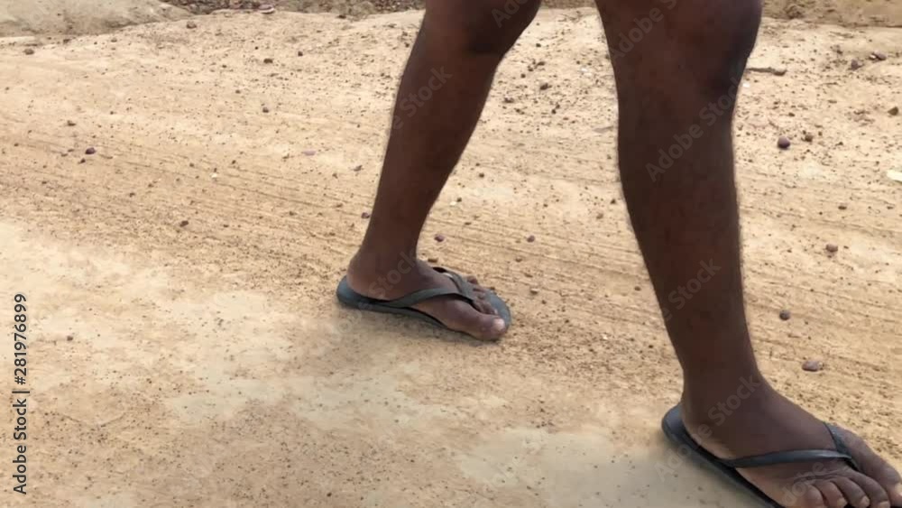 Poor man feet walking on a dirt road on a hot sunny day. Poor man feet walking on a dirt road on a hot sunny day.