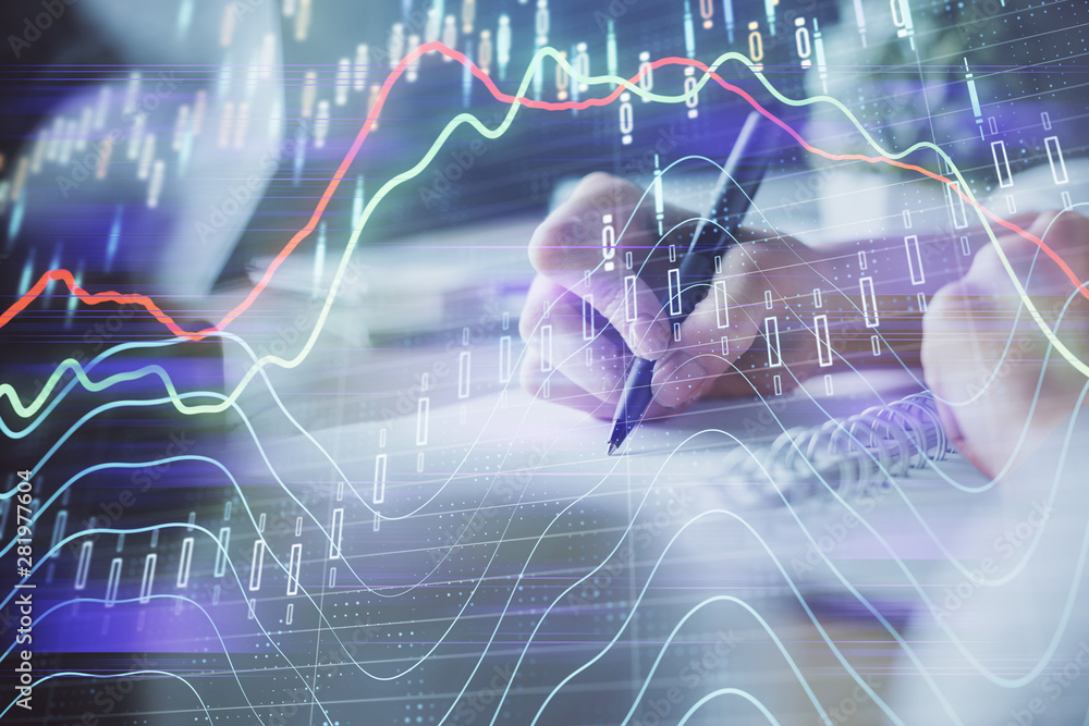 Financial forex graph displayed on hands taking notes background. Concept of research. Multi exposure Financial forex graph displayed on hands taking notes background. Concept of research. Multi exposure