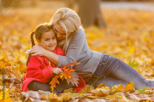 Cute family walking in a autumn park. Mother with little daughter