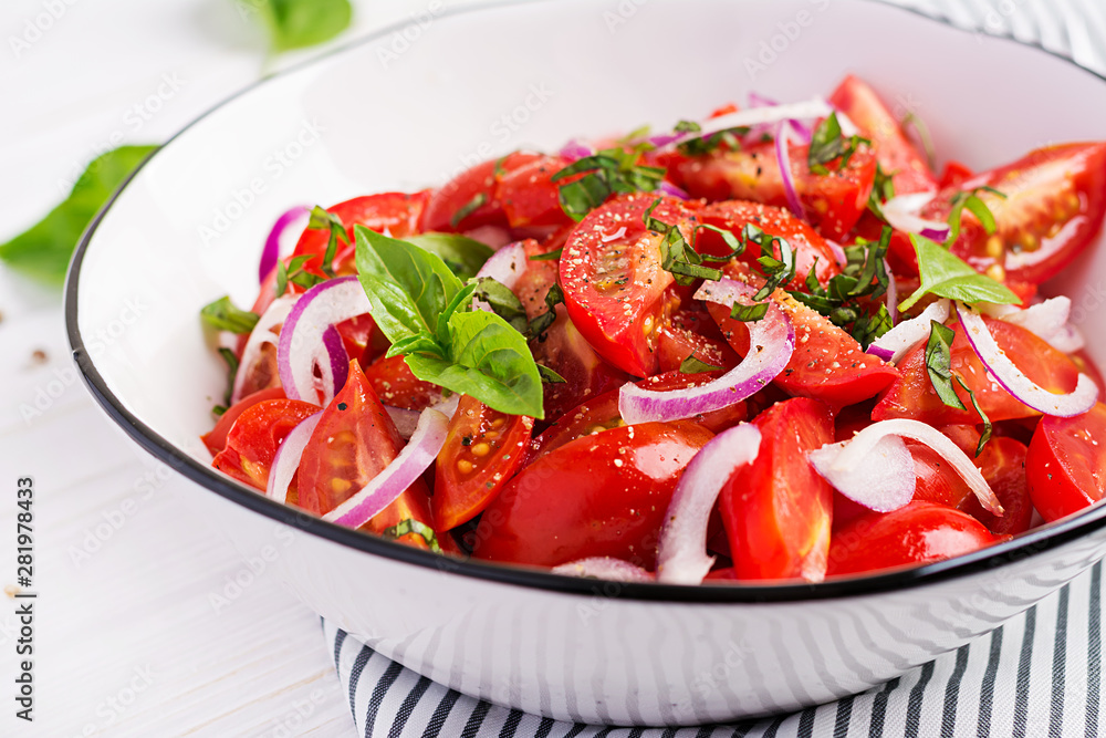 Tomato salad with basil and red onions. Homemade food.  Concept healthy meal. Vegan cuisine.