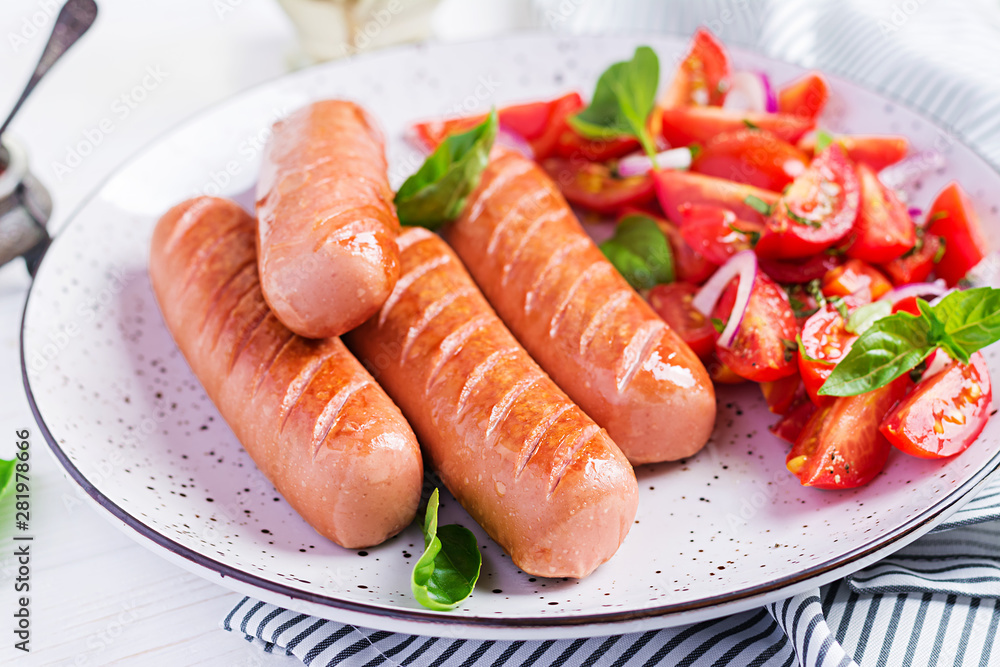 Grilled sausage with tomatoes, basil salad and red onions. BBQ menu. Grilled sausage with tomatoes, basil salad and red onions. BBQ menu.