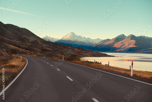 Scenic View of Mt Cook in New Zealand with soft blue sky, view from car windshield while driving along the road on ridges. Nature sightseeing view are popular for tourist for look around.