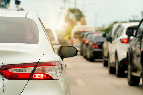 Brake of white car on asphalt roads during rush hours for travel or business work.