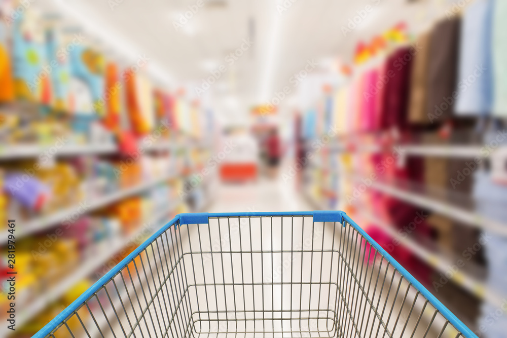Supermarket aisle with empty shopping cart with customer defocus background