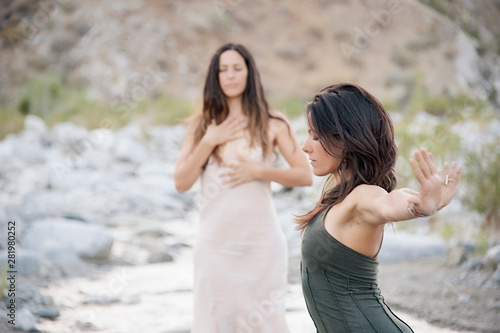 Obraz na plátně Two Wild Women dancing in desert wilderness nature.