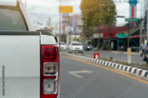 White pick up car on asphalt roads in the city at day.