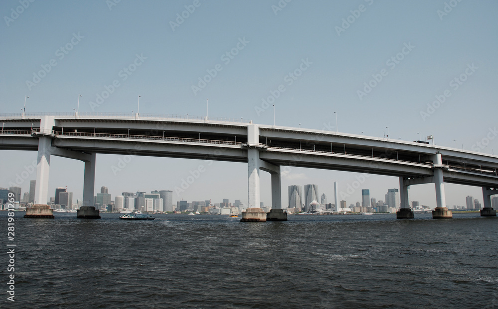 A large modern bridge crosses one of Tokyo's waterways A large modern bridge crosses one of Tokyo's waterways