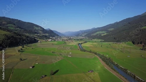Flight over of Salzach river alpine valley near the Uttendorf town at sunny summer day, in Land Salzburg, Austria. photo