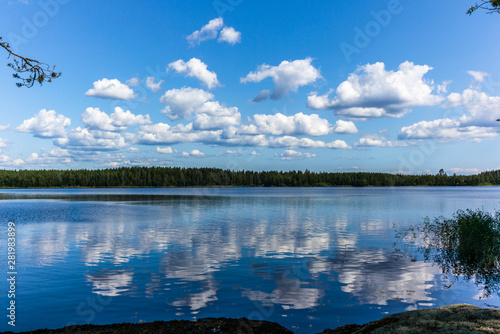 White clouds reflecting on the calm waters of the Saimaa lake in the Linnansaari National Park in Finland - 1